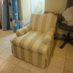 Custom upholstered chair with drop skirts.