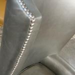 Custom built fanback chair with head to head nail trim and silver leather.