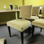 Custom  built dining room chair with walnut base and peekaboo back upholstered in velvet fabric.