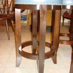 Custom round barstool with mahogany base and satin finish, nail detail with leather stripping.  