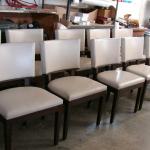 Set of 10 custom built dining room chairs in leather with baseball stitchting, exposed keyhole back with walnut trim, base, and legs.  