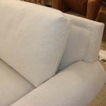 Reupholstered sectional with picture framed banding treatment around back.