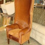 Custom built hair-on cowhide chair with head to head nail trim, suede outside back and seat cushion, walnut legs.