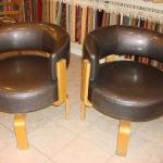 Reupholstered salon waiting room chairs in vintage vinyl.